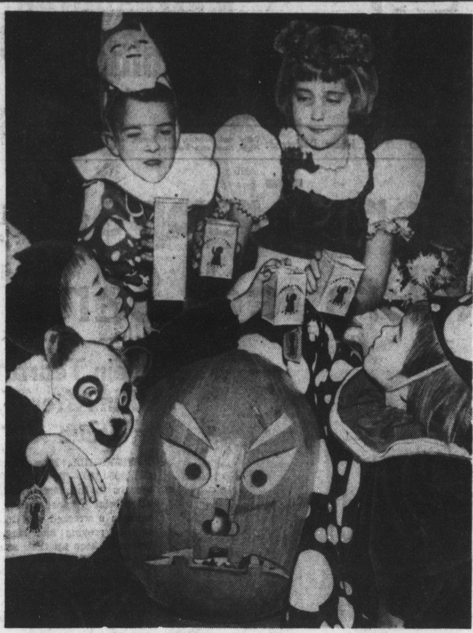 Four costumed children with UNICEF boxes around a carved pumpkin