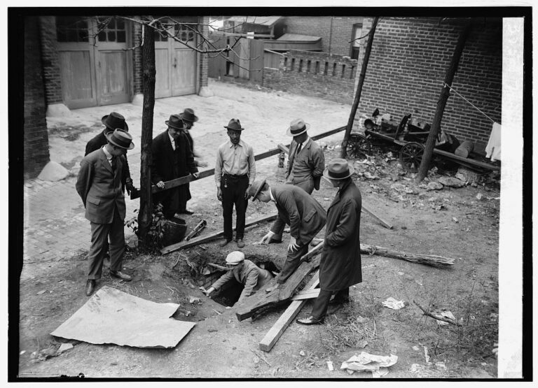 A 1924 photo shows workmen in Washington D.C. gathered around a large hole in the ground behind a house, revealing a set of concrete tunnels underneath. This accidental discovery of elaborate secret tunnels at Harrison Dyar's old home at 1512 21st St. NW kicked off a mystery that fascinated the city.