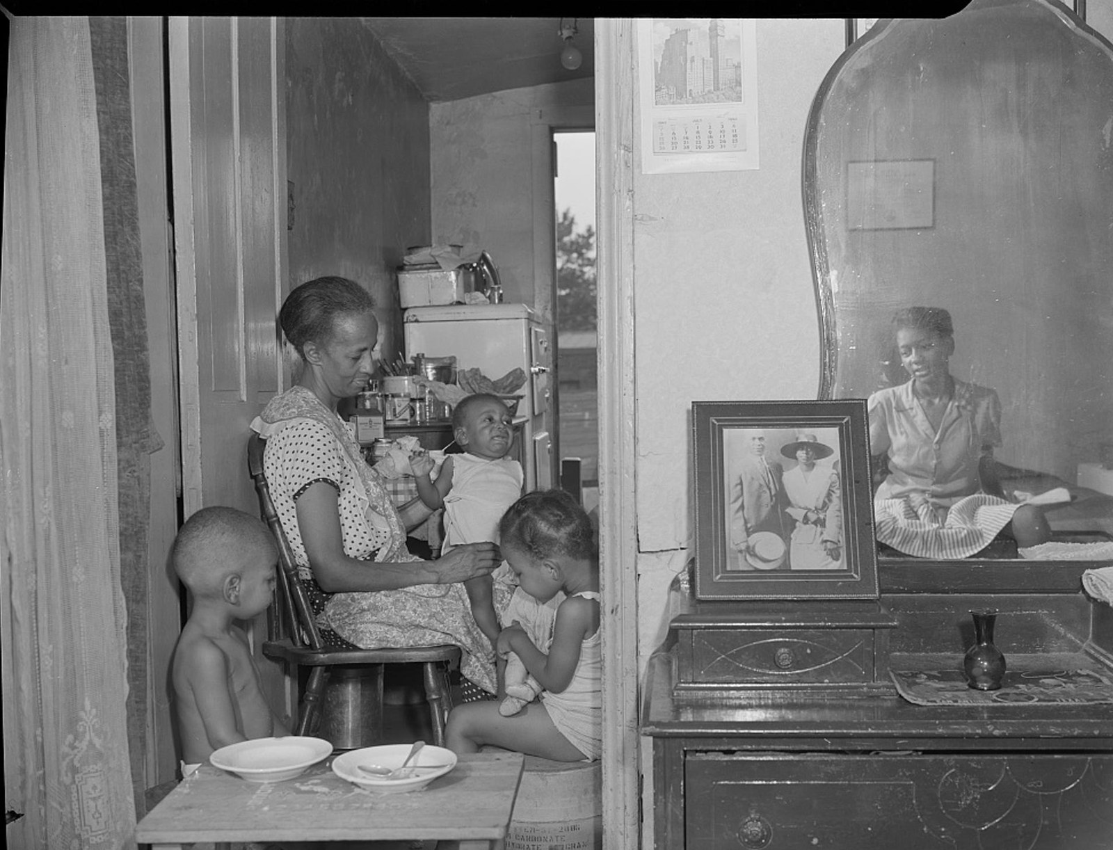 Ella Watson with three grandchildren and her adopted daughter at home, 1942