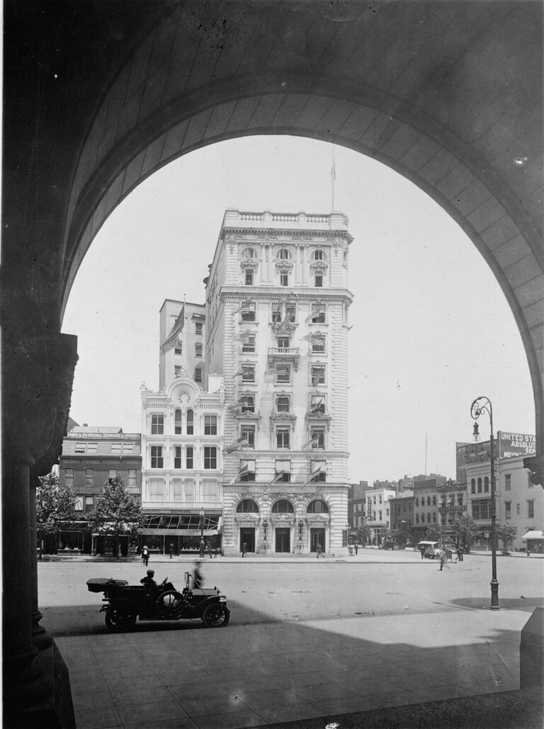 Evening Star Building at 11th Street and Pennsylvania Avenue NW, seen through an arch of the Old Post Office, early 1900s