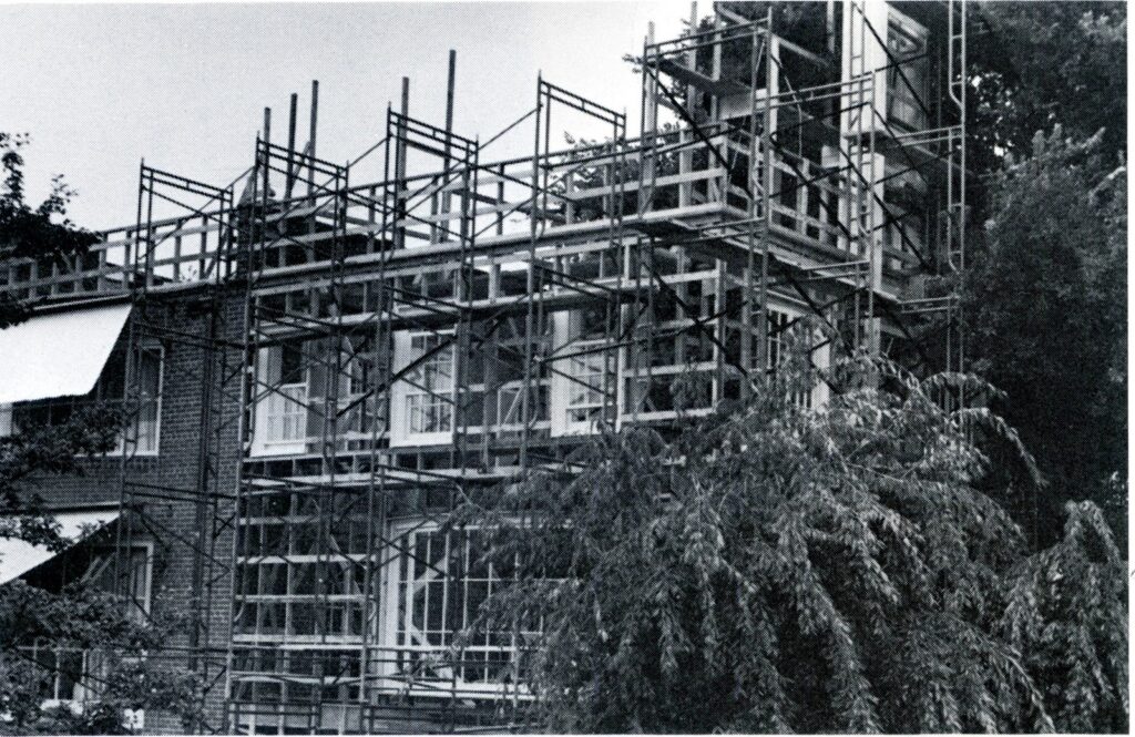 Scaffolding of a temporary wing built onto the front of a brick house on Prospect Street