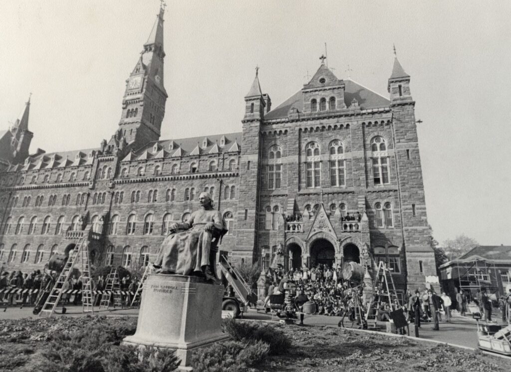 Crowds, ladders and film equipment in front of Healy Hall at Georgetown University