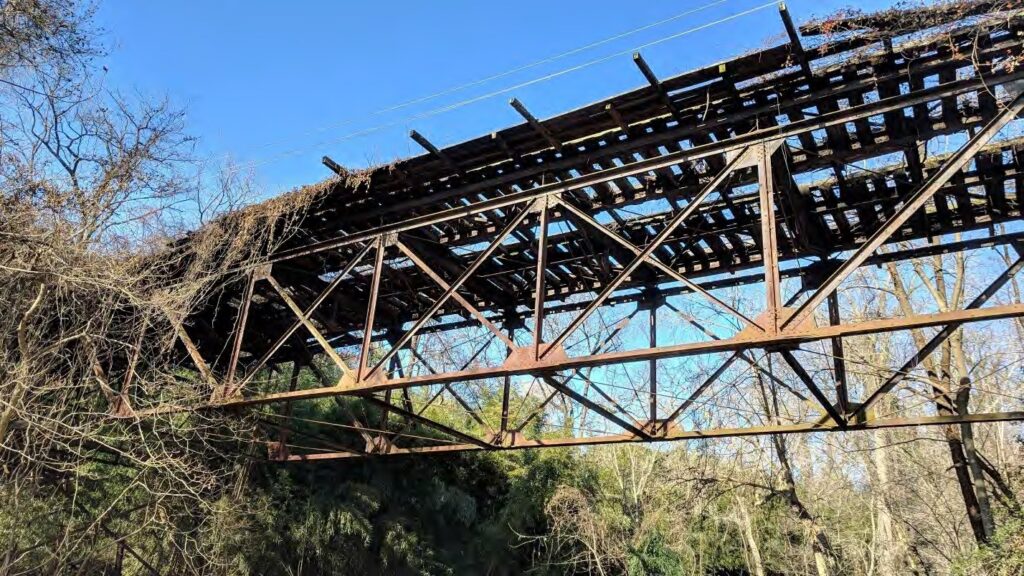 The rusted 100-foot steel truss of the Foundry Branch trestle in 2019