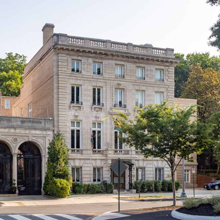Kenya’s embassy at 2249 R Street NW, with its pale façade, flags, and entrance arches