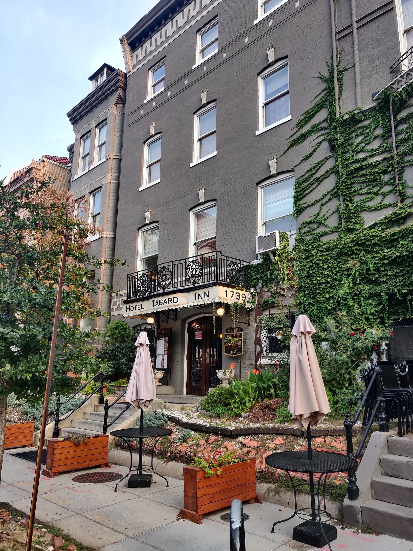 The Tabard Inn at 1739 N Street NW in 2021, with the same iron balcony and Hotel Tabard Inn marquee