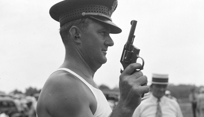 Crack shot of White House police force. Washington, D.C., Aug. 10. Outstanding marksman of the White House police force is Roland Ford, today averaged 294 bullseyes out of a possible 300 while shooting in competition with marksmen from other agencies in the Treasury Department. Forty-eight experts competed for medals and cup for themselves and their services in the friendly matches, 8/10/37