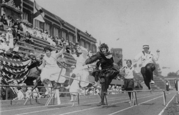Women competing in low hurdle race