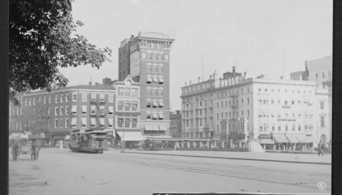 View from Pennsylvania Avenue NW looking east towards the buildings on the east side of 15th Street as well as the southeast corner of 15th and G Streets. Streetcars and horses and wagons are on streets.