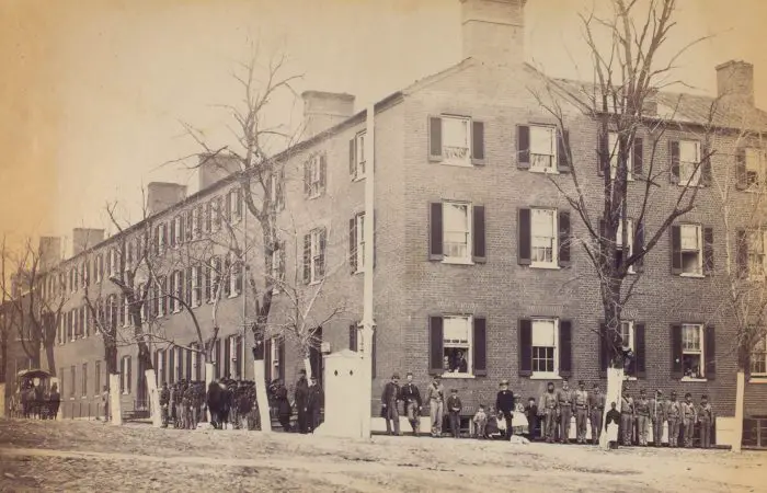 View on Pennsylvania Avenue, Washington, D.C.[Soldiers, civilians and children stand in front of a large brick corner building.]